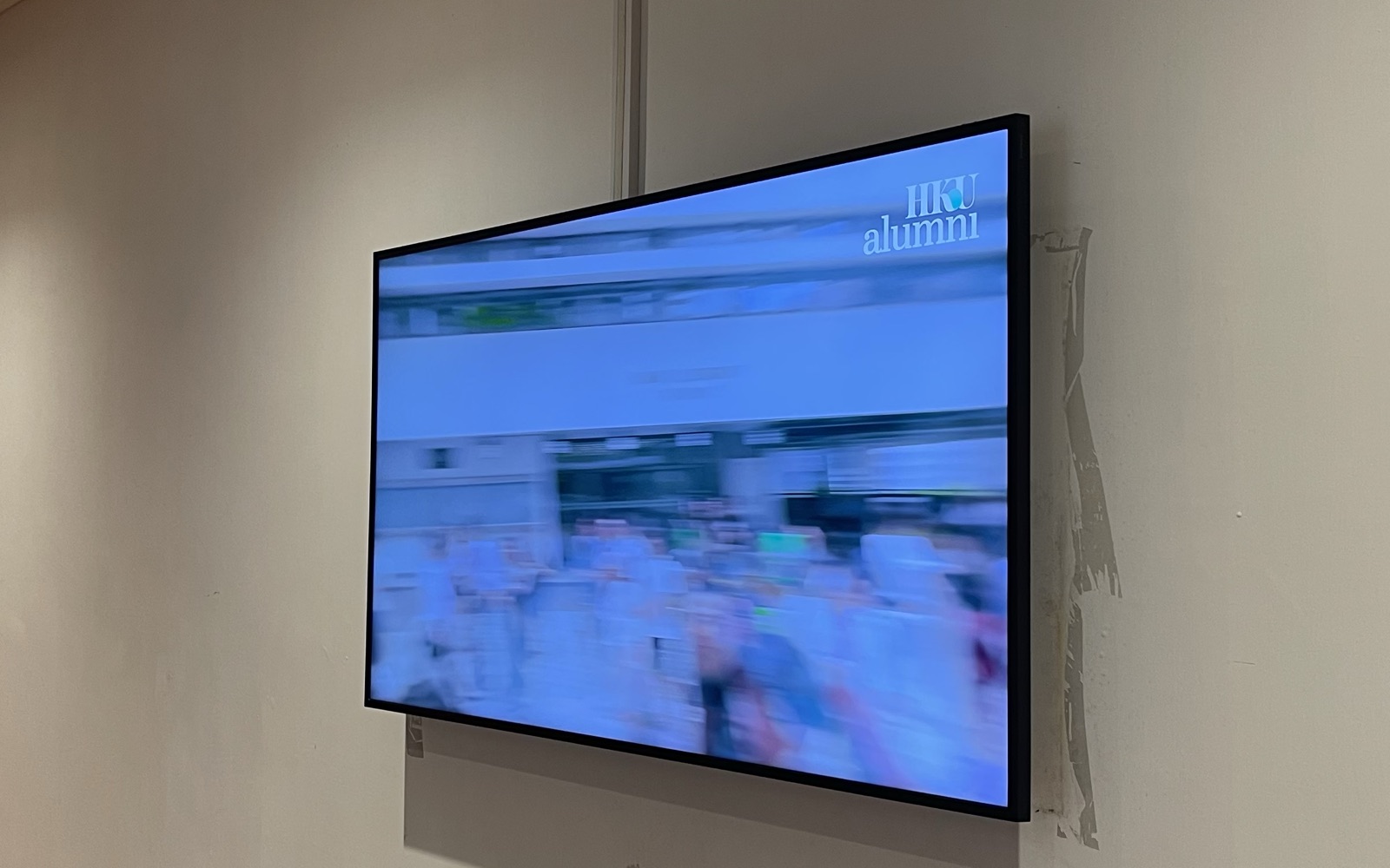 A U-Vision screen on the corridor wall on the second floor of Jockey Club Tower